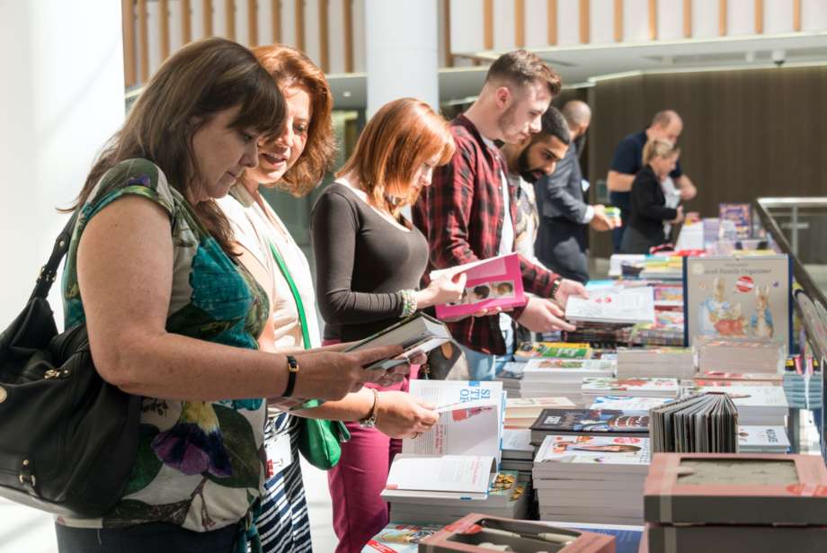 People Browsing Books from Stand